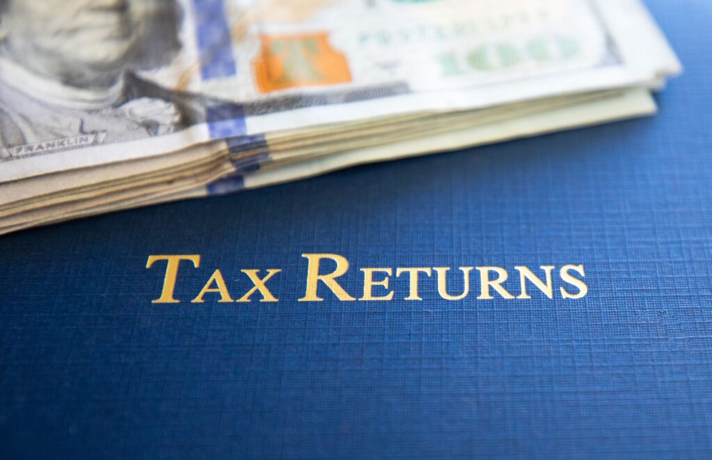 dollars and folder with tax returns